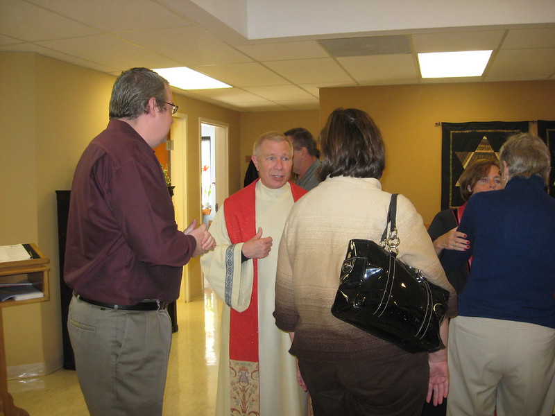 Rev. Perry in conversation with members during fellowship hour.