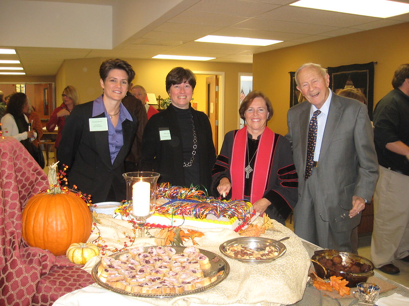 Holy Covenant members and clergy gathered behind the celebration cake.