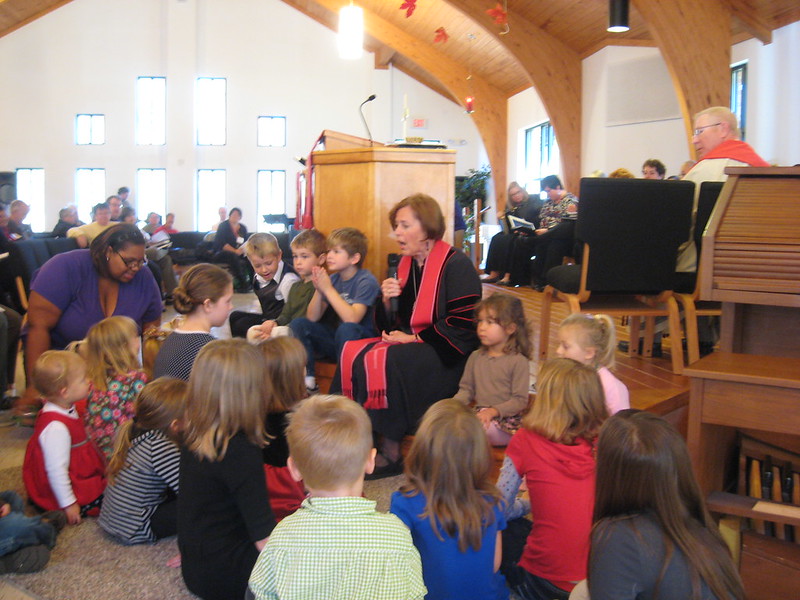 Children gather on the chancel steps during a children’s message.