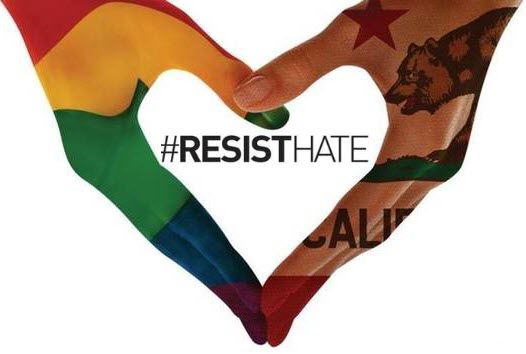 Two hands forming a heart shapeāone painted with the rainbow Pride flag, the other with the California state flagāsurrounding the words