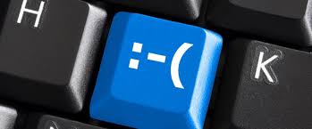 A white keyboard with a bright blue heart key, symbolizing grace and compassion in digital communication.