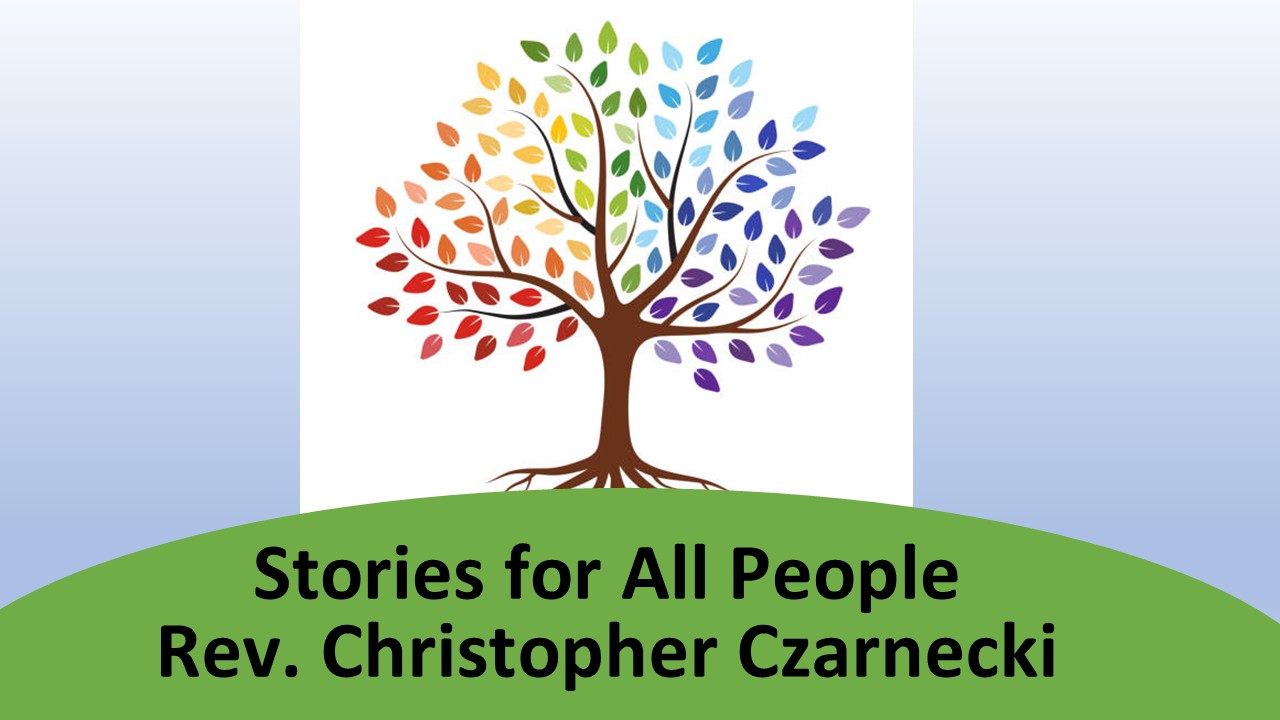 Pastor Chris sitting with children during the children's sermon, smiling as he shares an illustrated story.