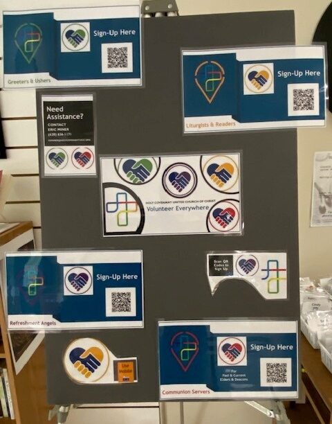 Volunteer Everywhere station in the Gathering Room with colorful icons and QR sign-up cards for each ministry