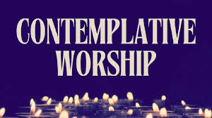 A calm, light-washed sanctuary with a single altar table, arranged for quiet reflection and adorned with candles and a simple cross.