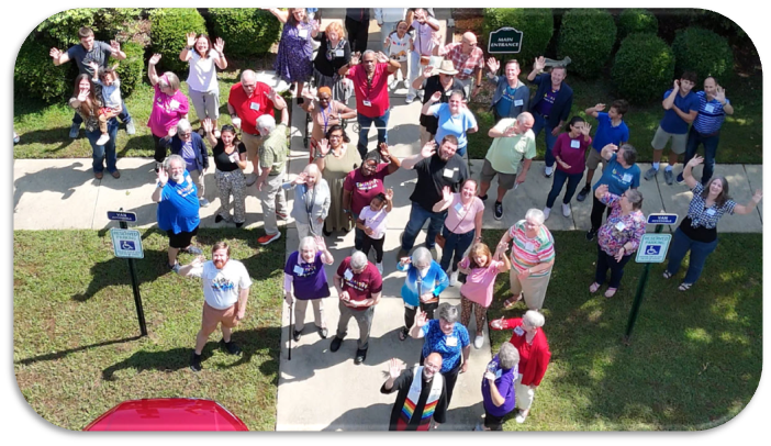 Holy Covenant Congregants at facility front door waving to the sky