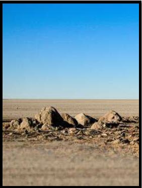 Desert landscape with scattered stones under open sky, evoking wilderness, promise, and the long journey of Lent.